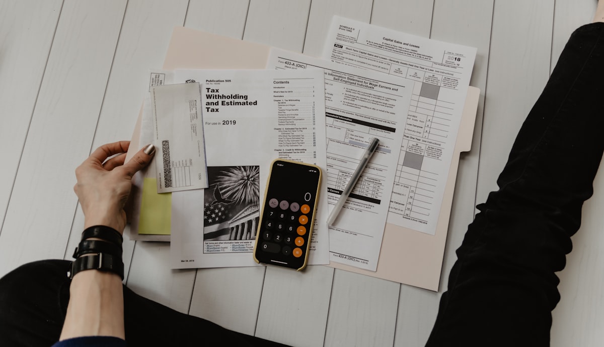 Tax documents and a calculator laid out for review